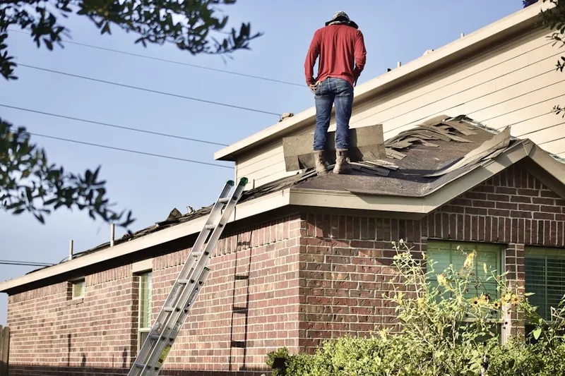 Professional roofer working on a residential roof in Fullerton